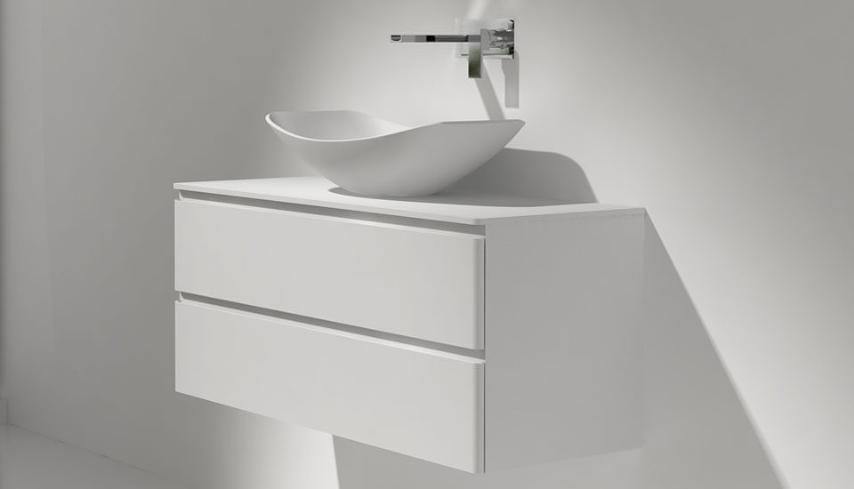 The hammock washing basin sits above the counter on a cabinet, this vessel sink design complements the hammock bath collection.