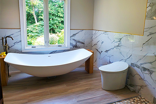 Full bathroom view featuring the Oasis Hammock Bath with marble look wall tiles, timber floors and modern toilet.